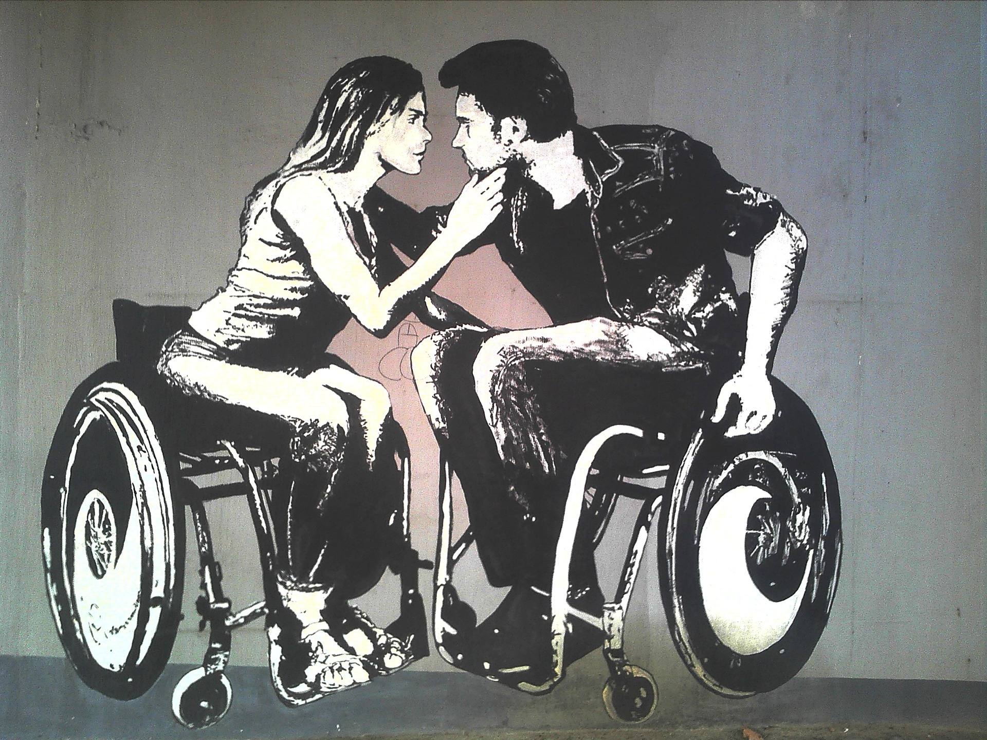 Graffiti Grafitti med mann og dame i rullestol som er på vei til å kysse