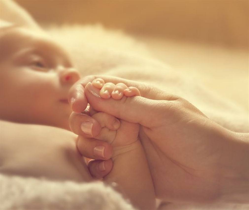 Bilde metabolske Baby holder en voksen sin hånd